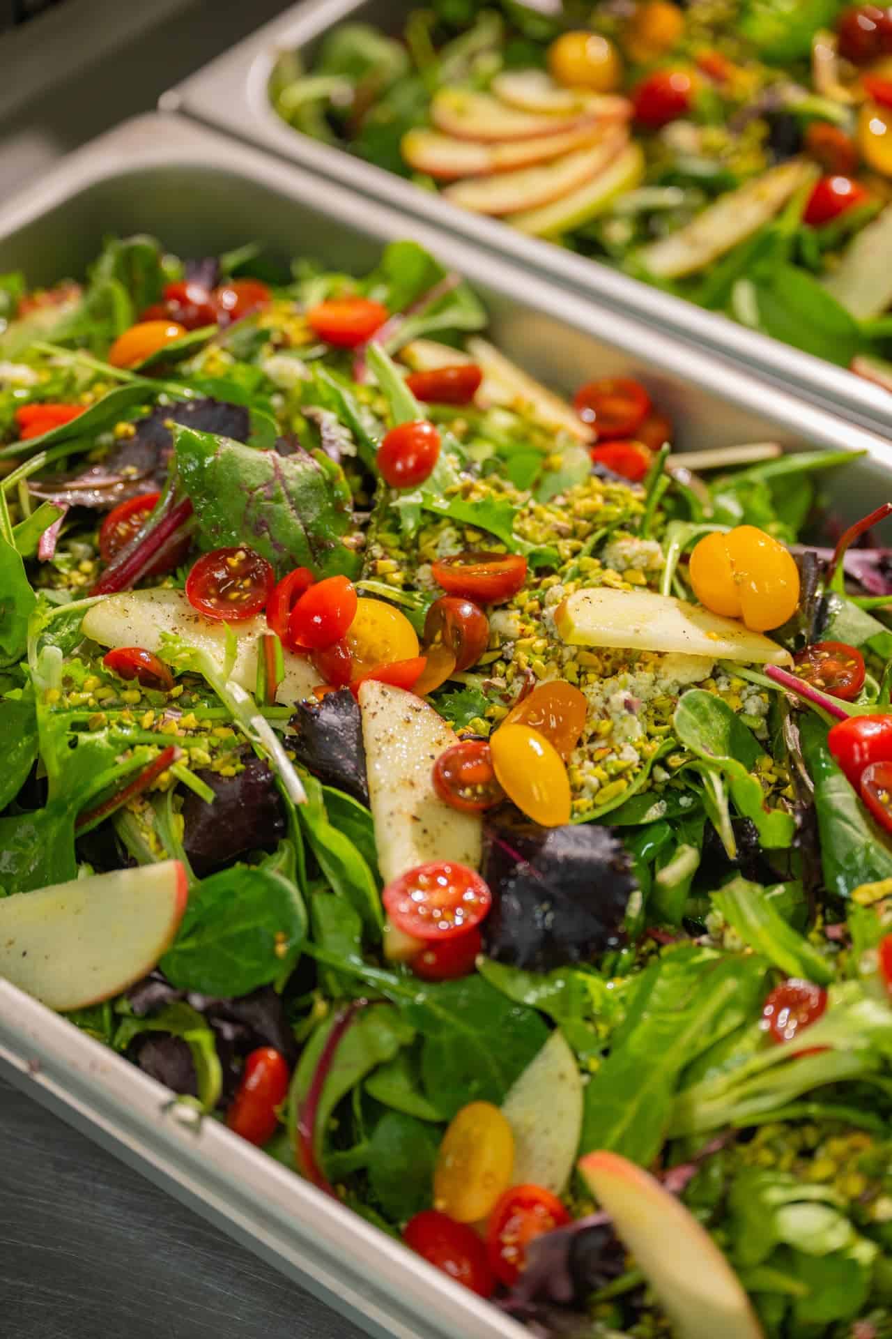 Fresh salad with apples and tomatoes prepared for a catered event in Sedona