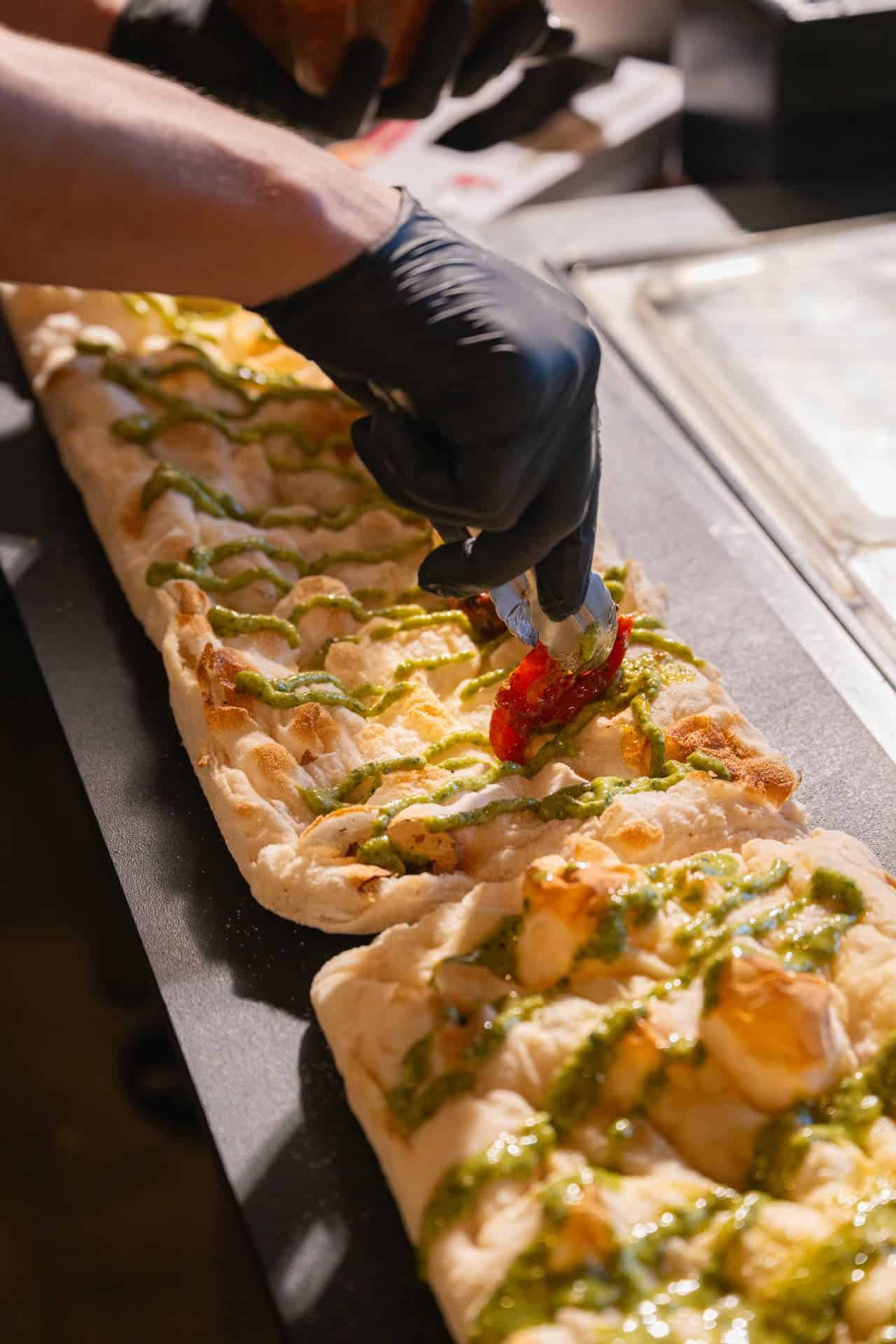 Vespa chef finishing pinsa romana for Sedona catering